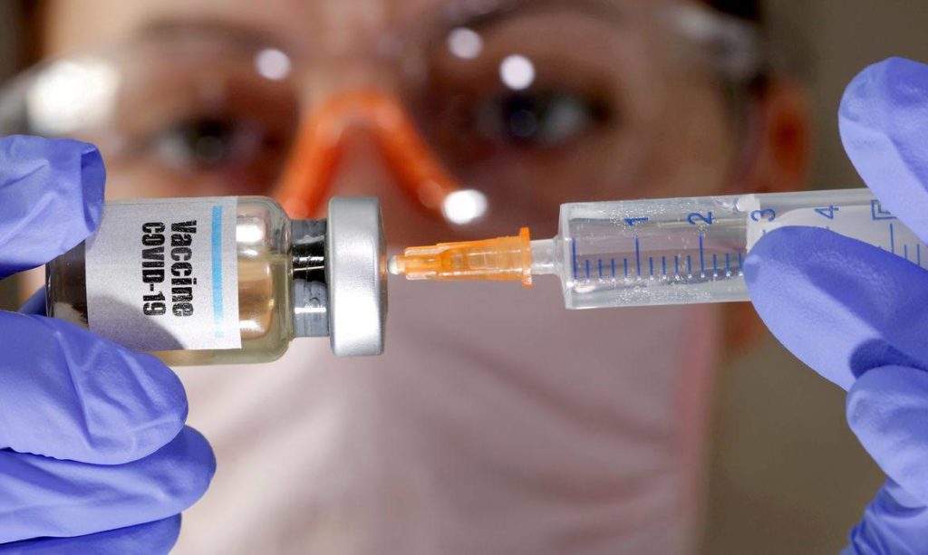 Enfermeiro com uma seringa e frasco de vacina